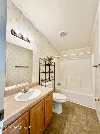 a bathroom with a toilet sink and shower