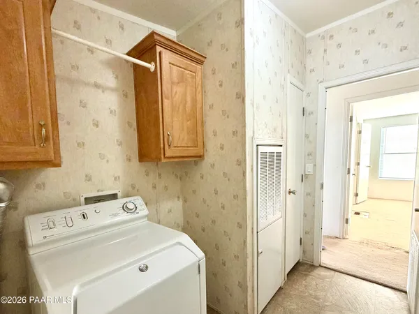 a view of a storage & utility room with dryer and washer