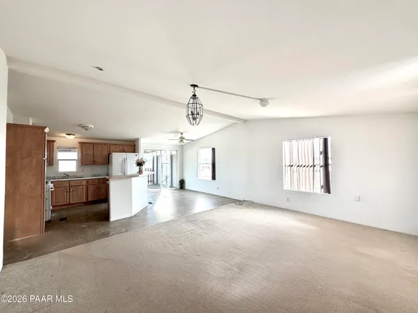 a view of a kitchen with a sink and a refrigerator