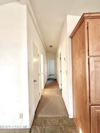 a view of a hallway with white walls