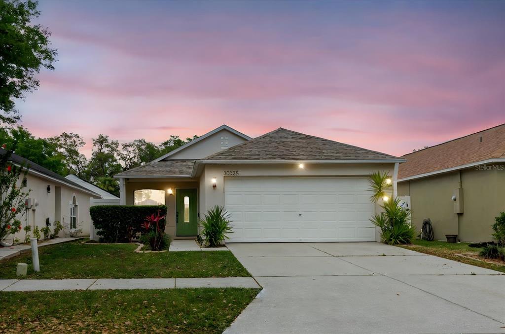 a front view of a house with a yard and garage