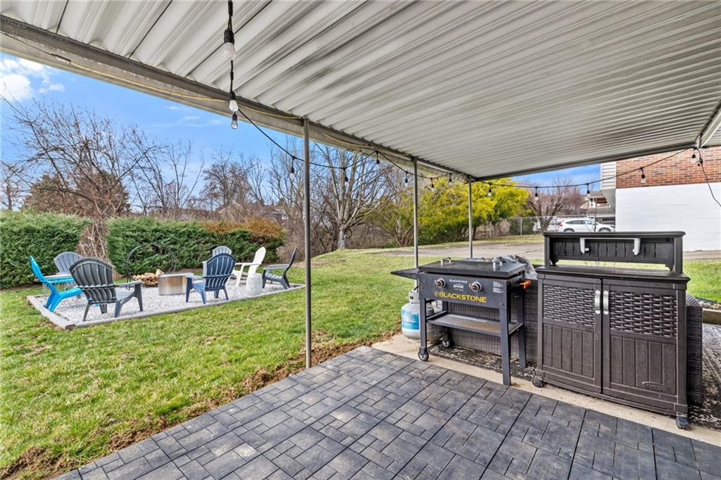1075 Fiddleback Drive McKees Rocks, PA 15136 - Photo 28 of 34 a view of a patio with table and chairs potted plants with wooden floor and fence