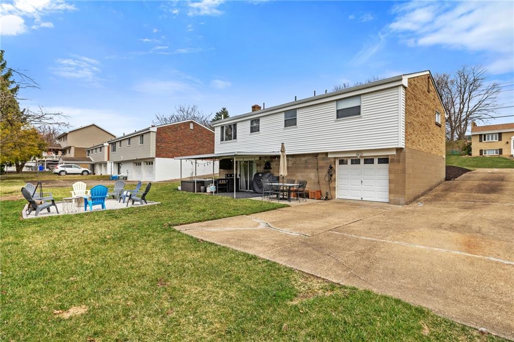 1075 Fiddleback Drive McKees Rocks, PA 15136 - Photo 29 of 34 a front view of a house with a yard and garage