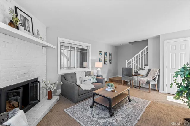 a living room with furniture a rug and a fireplace
