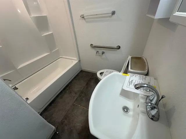 a bathroom with a sink and mirror