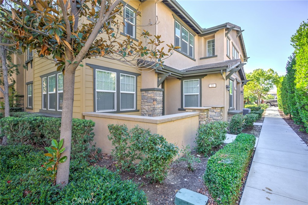 16001 Chase Road, Unit 53 Fontana, CA 92336 - Photo 1 of 32 a front view of a house with garden