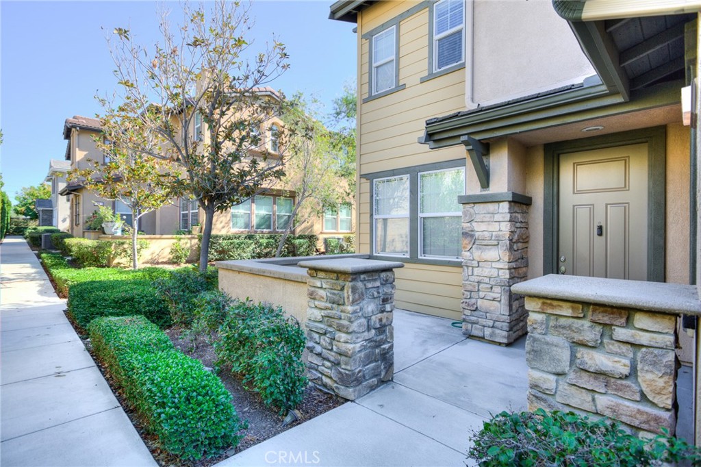 16001 Chase Road, Unit 53 Fontana, CA 92336 - Photo 2 of 32 a front view of a house with a garden