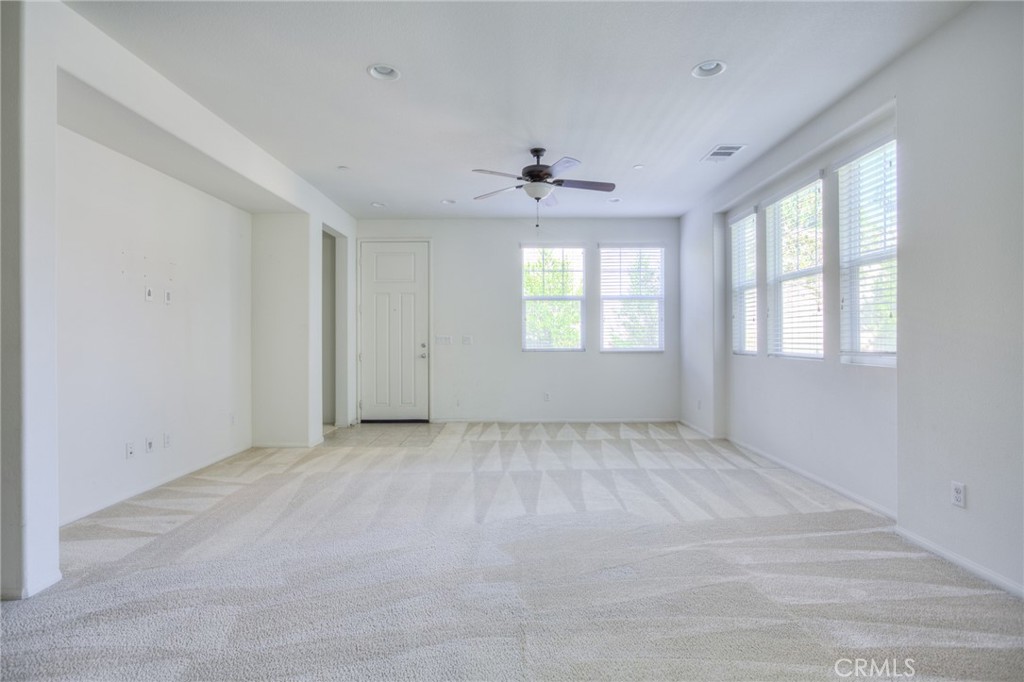 16001 Chase Road, Unit 53 Fontana, CA 92336 - Photo 5 of 32 an empty room with windows and ceiling fan