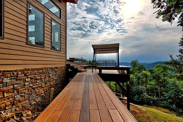 892 Cunningham Lane Baxter, TN 38544 - Photo 18 of 28 a view of a balcony with wooden floor and large trees