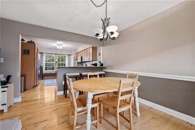 a view of a dining room with furniture wooden floor and chandelier