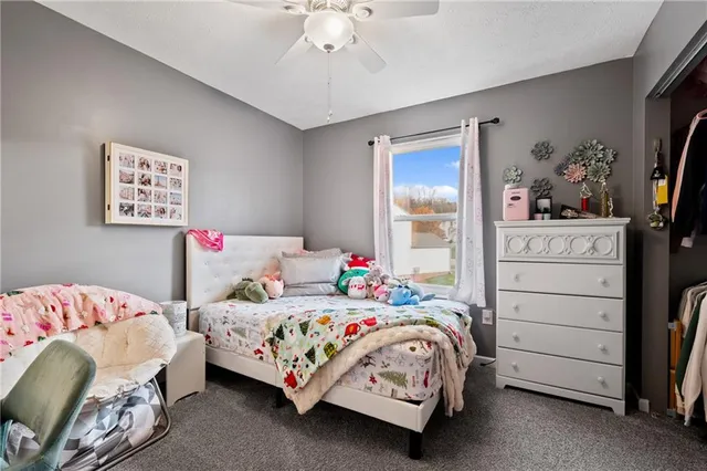 a bedroom with a bed and a dresser in it