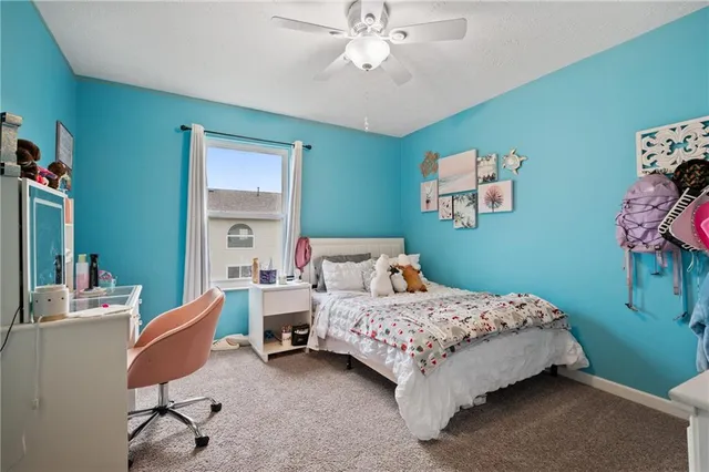 a bedroom with a bed and a chair