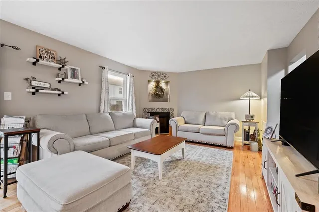 a living room with furniture flat screen tv and a fireplace