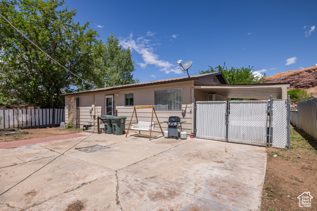 527 Palisade Drive Moab, UT 84532 - Photo 27 of 51 View of rear of home featuring a gate and fence