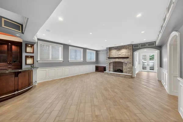a view of empty room with wooden floor and fireplace