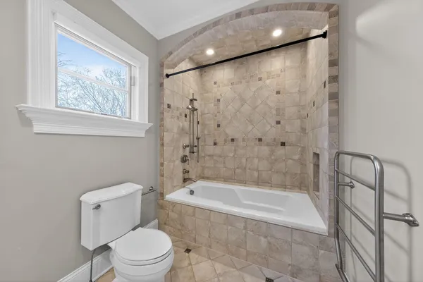 a bathroom with a bathtub and a toilet