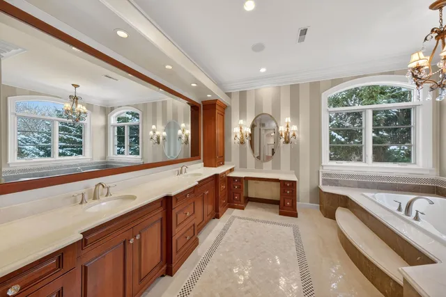 a large bathroom with a large tub and sink