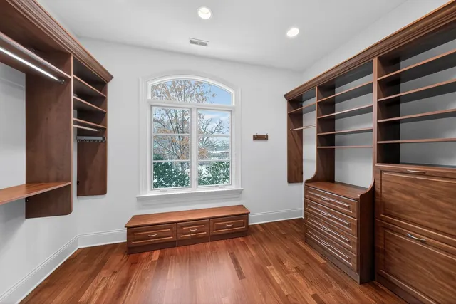 a view of room with wooden floor and windows