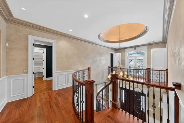 a view of a hallway with wooden floor and furniture