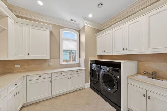 a utility room with sink dryer and washer