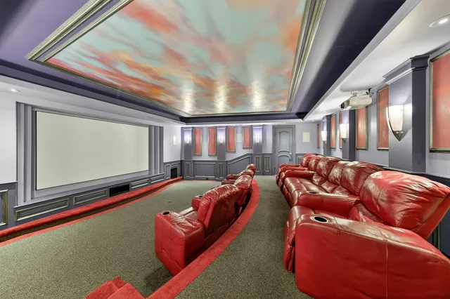 a living room with furniture and floor to ceiling window