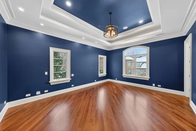 an empty room with a ceiling fan and windows