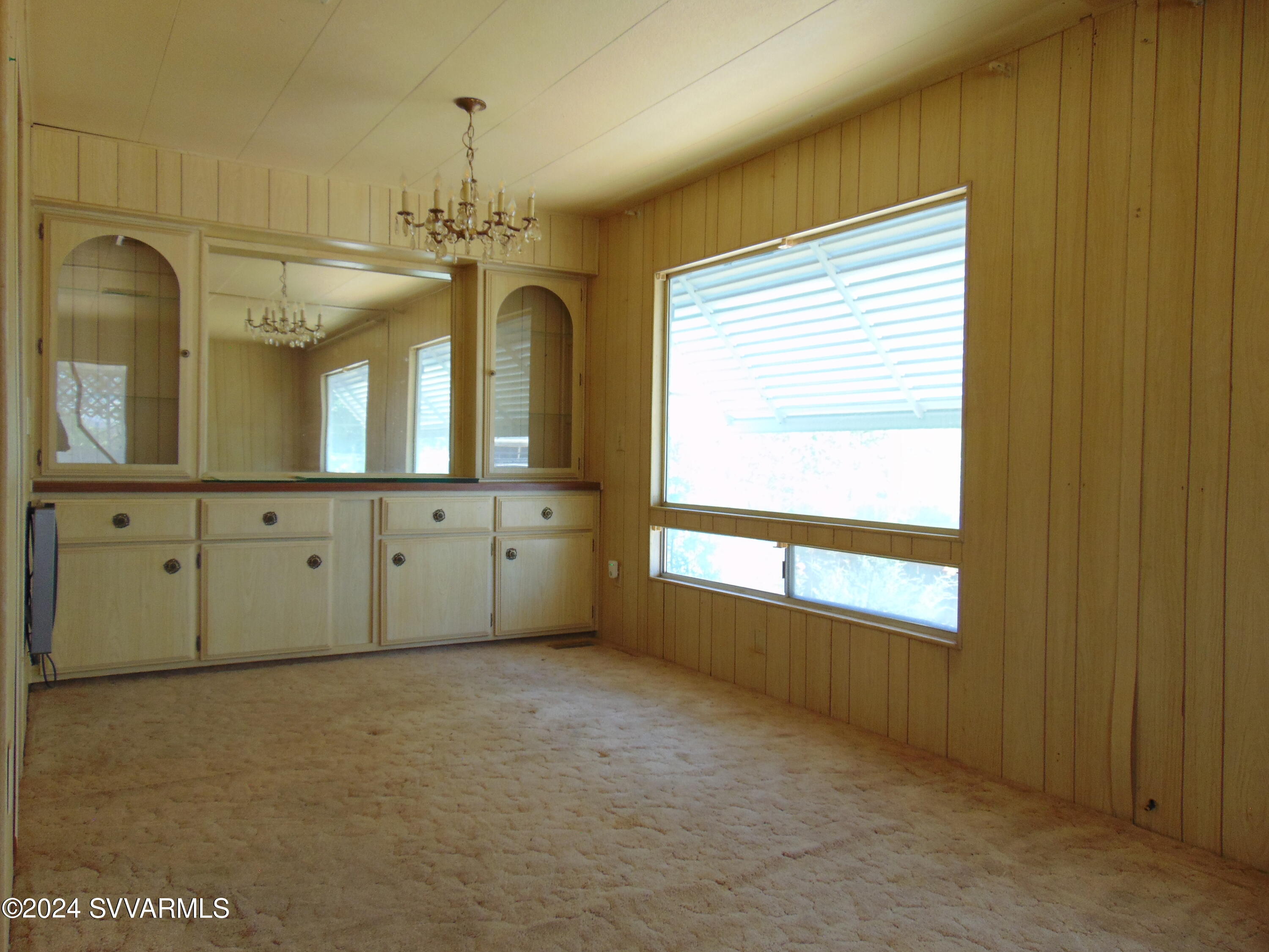 4665 Quail Hollow Road Rimrock, AZ 86335 - Photo 11 of 21 an empty room with a window and chandelier