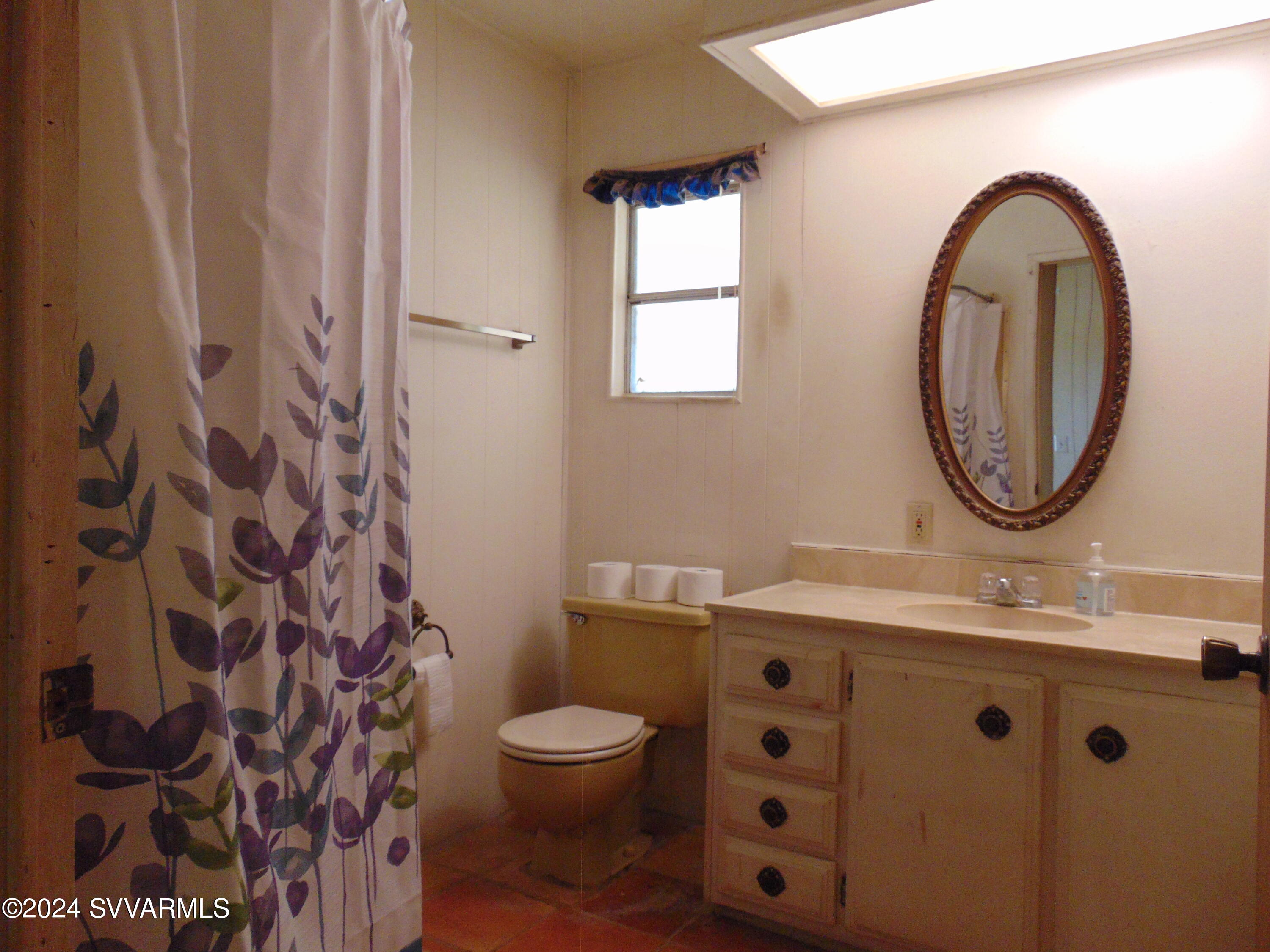 4665 Quail Hollow Road Rimrock, AZ 86335 - Photo 16 of 21 a bathroom with a sink a toilet and a mirror
