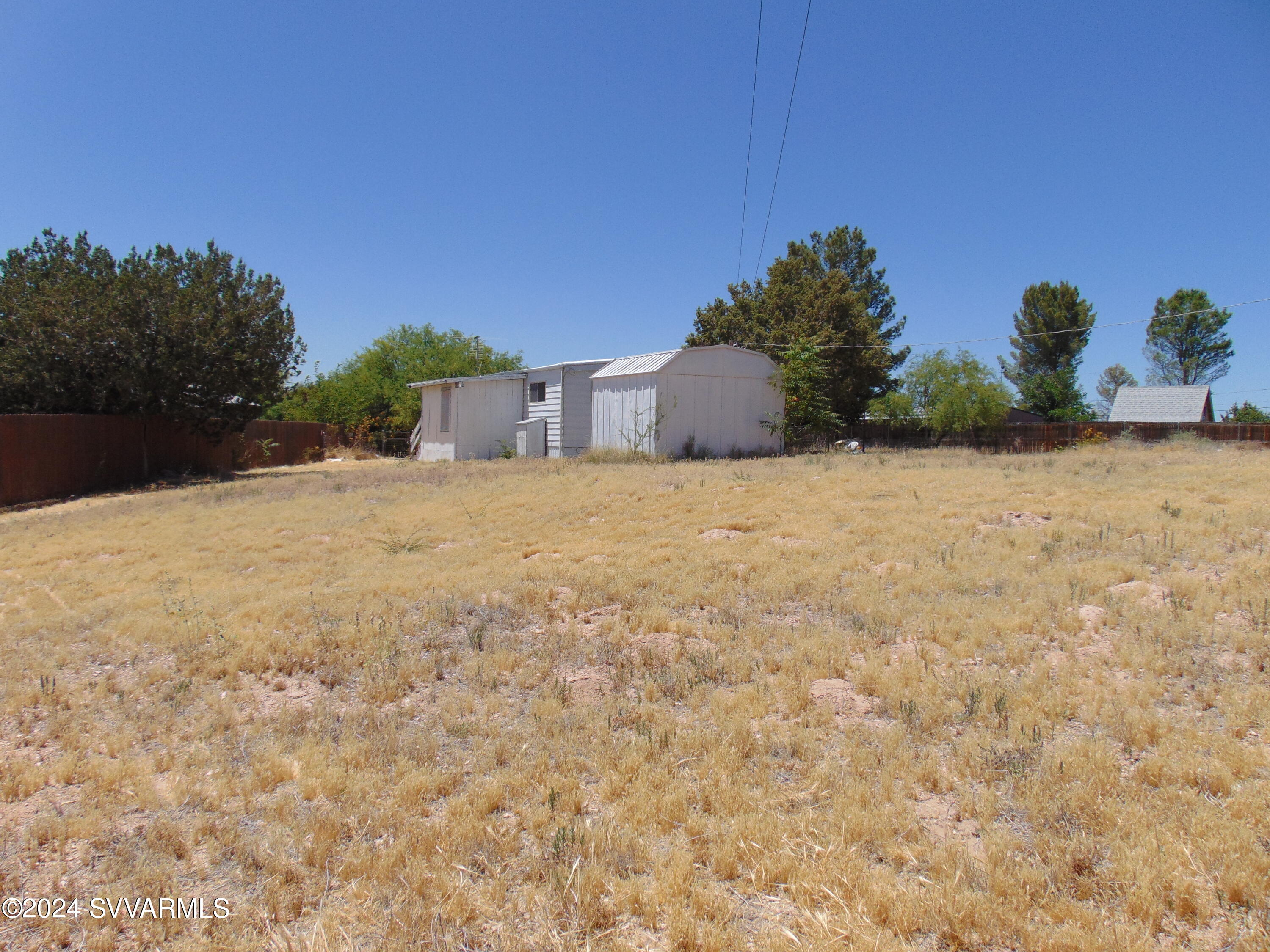 4665 Quail Hollow Road Rimrock, AZ 86335 - Photo 4 of 21 a view of a yard with a tree