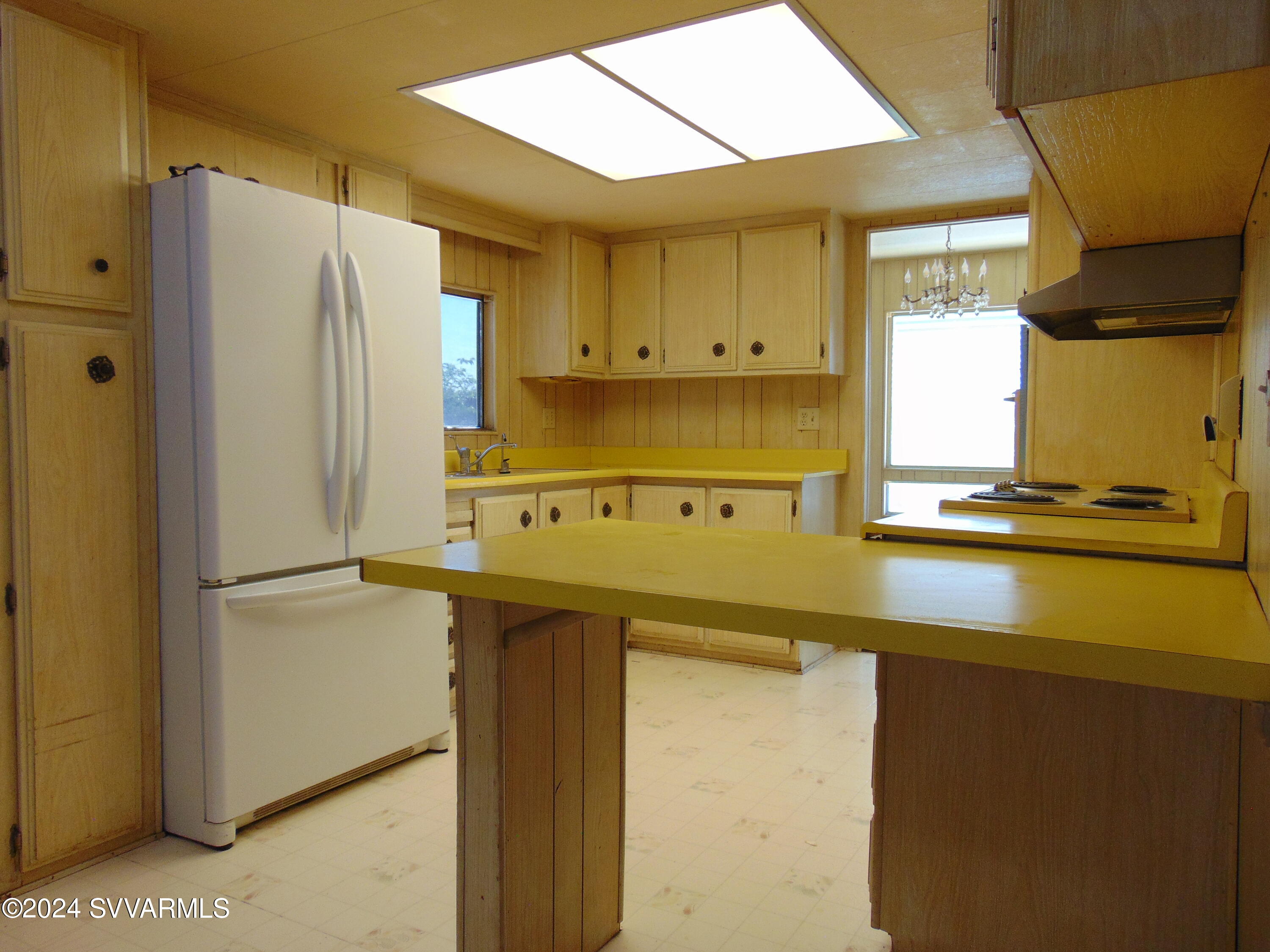 4665 Quail Hollow Road Rimrock, AZ 86335 - Photo 7 of 21 a kitchen with a refrigerator and a sink