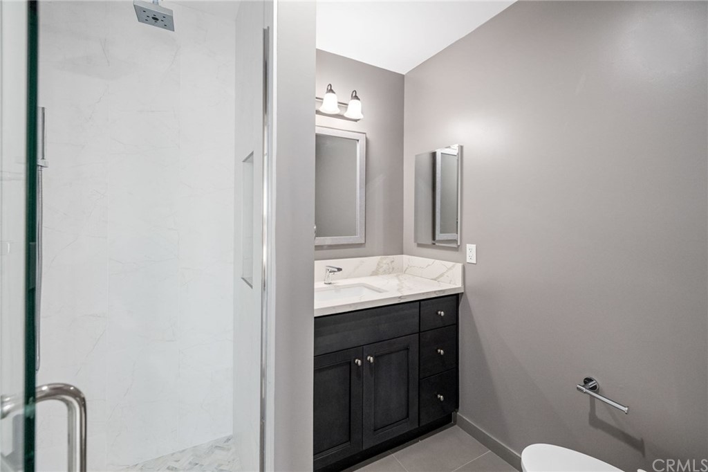 5 Clipper Road, Unit A Rancho Palos Verdes, CA 90275 - Photo 15 of 18 a bathroom with a granite countertop sink and a mirror
