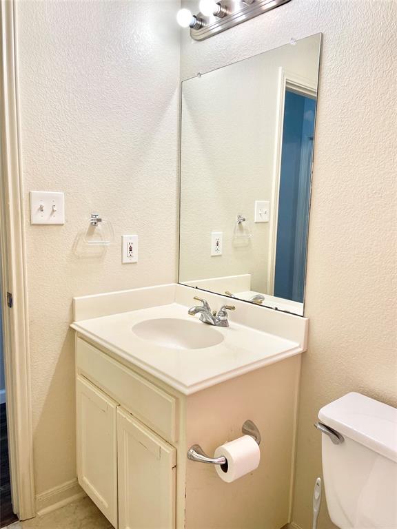 207 Kates Way Hutto, TX 78634 - Photo 10 of 24 Bathroom vanity featuring a white countertop with integrated sink, chrome faucet, and under-sink cabinetry