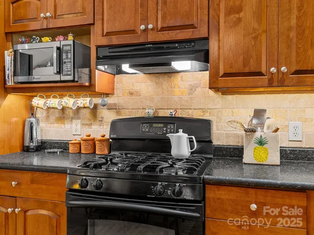 a stove top oven sitting inside of a kitchen