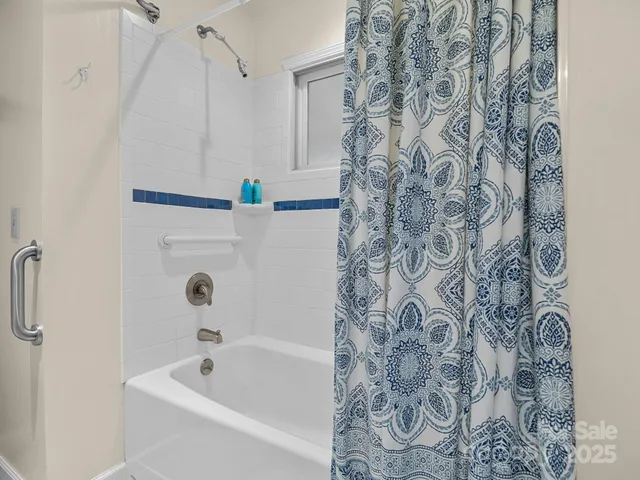 a bathroom with a bathtub and shower