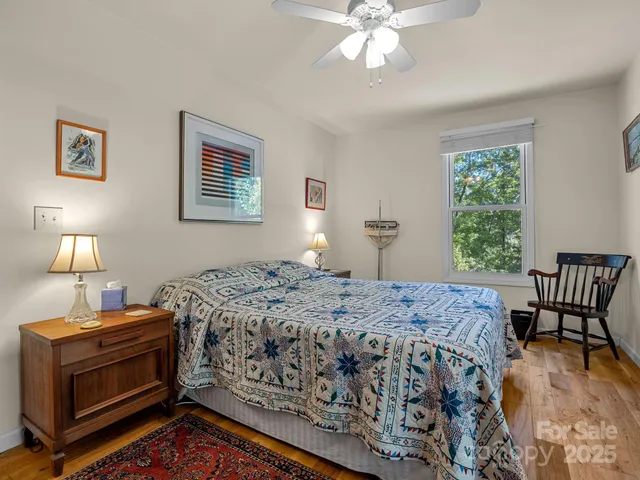a bedroom with a bed and a lamp on table