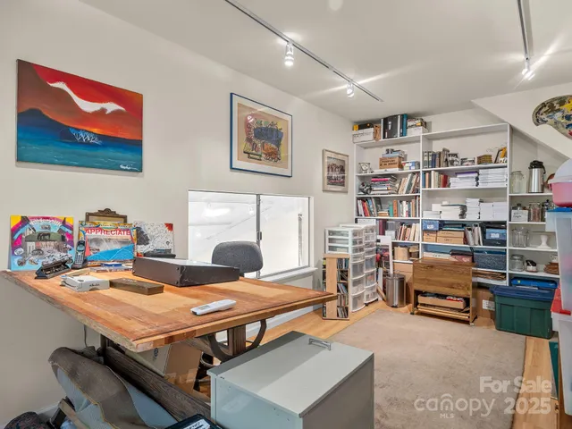 a bedroom with furniture and a book shelf
