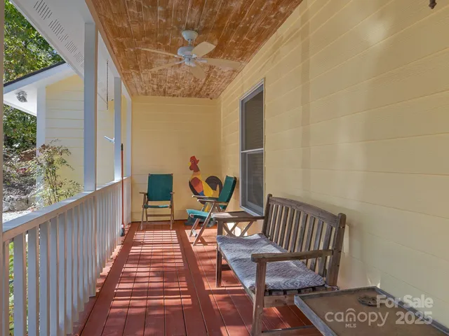 a balcony with wooden floor and outdoor seating