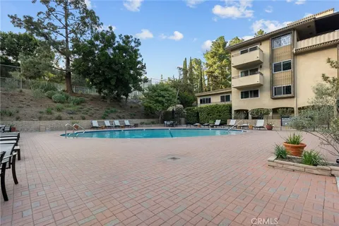 a swimming pool with outdoor seating and yard