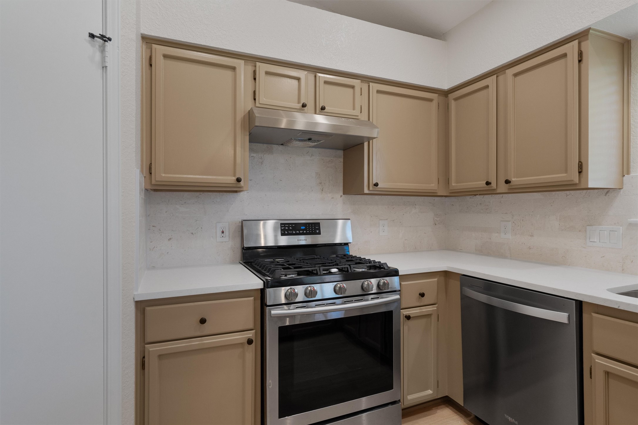 1401 Plum Creek Road Cedar Park, TX 78613 - Photo 12 of 30 Kitchen featuring stainless steel appliances, backsplash, cream cabinets, and light stone counters