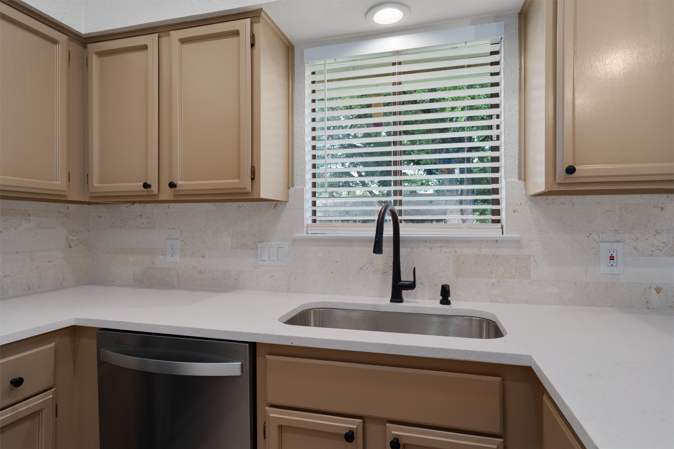 1401 Plum Creek Road Cedar Park, TX 78613 - Photo 13 of 30 Kitchen featuring dishwasher, light stone countertops, light wood finish cabinetry, and backsplash