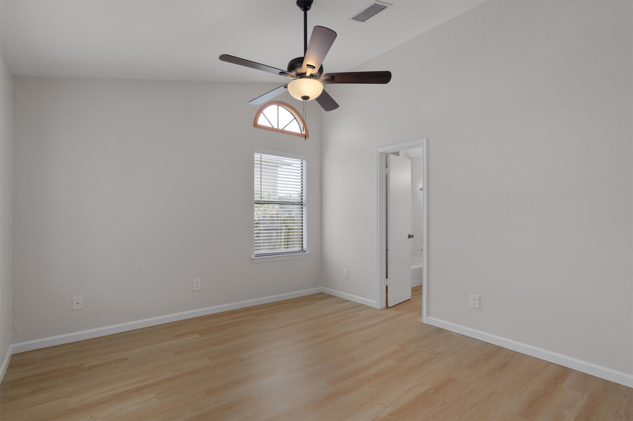 1401 Plum Creek Road Cedar Park, TX 78613 - Photo 14 of 30 Empty room with light wood-style floors, vaulted ceiling, and a ceiling fan