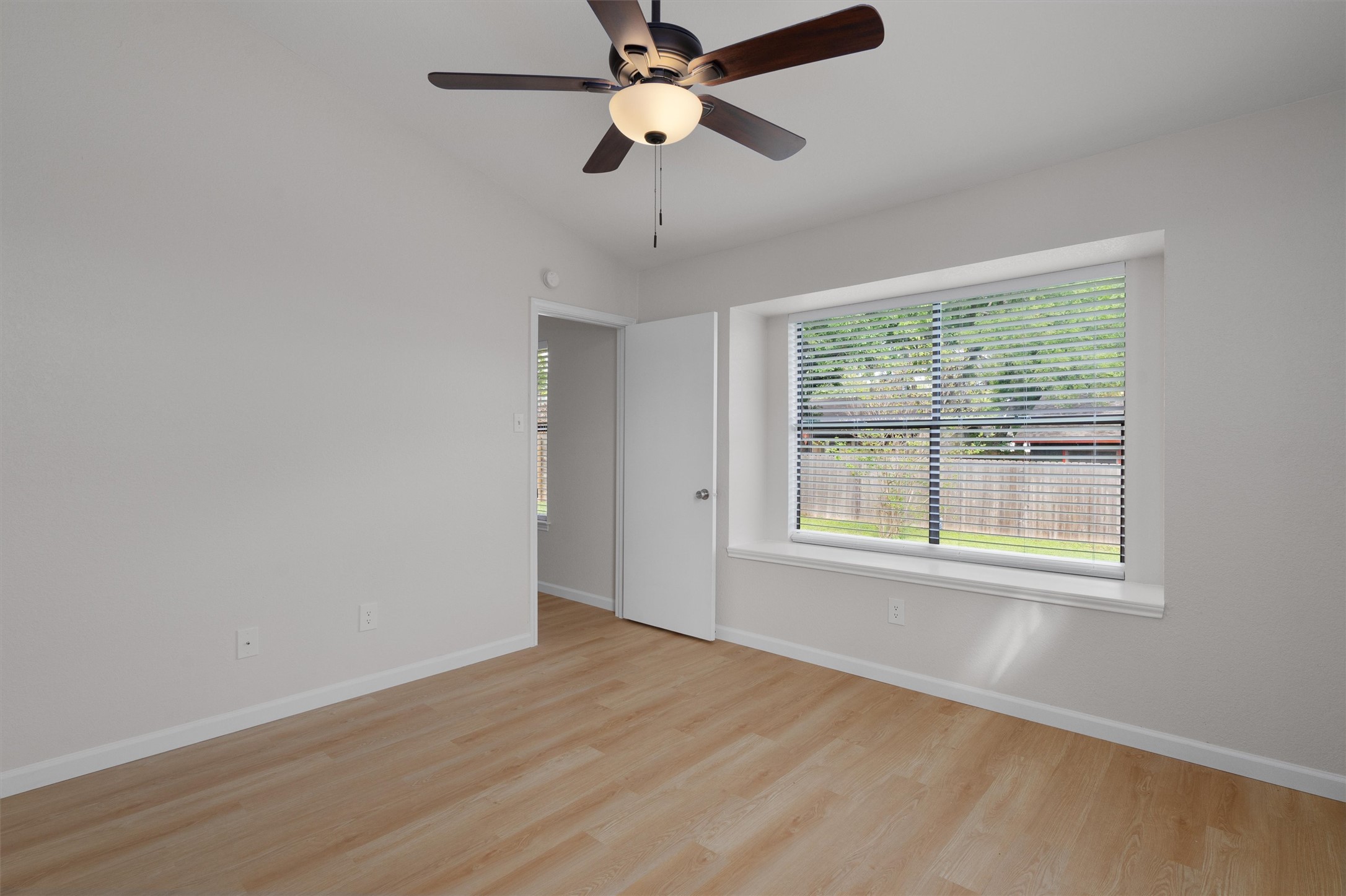 1401 Plum Creek Road Cedar Park, TX 78613 - Photo 15 of 30 Unfurnished room featuring light wood finished floors, a ceiling fan, and lofted ceiling