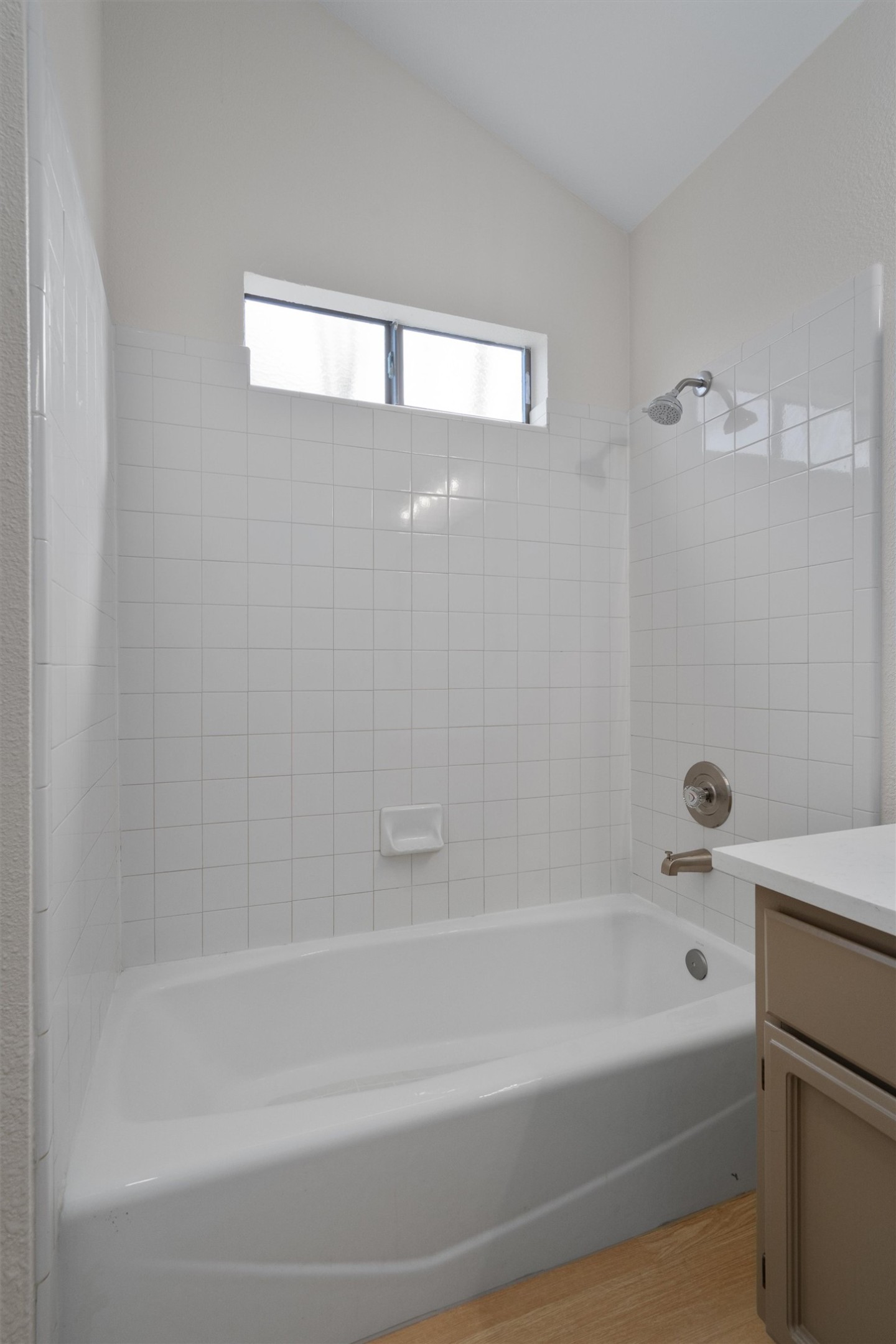 1401 Plum Creek Road Cedar Park, TX 78613 - Photo 17 of 30 Full bathroom featuring vanity, bathing tub / shower combination, light wood finished floors, and vaulted ceiling