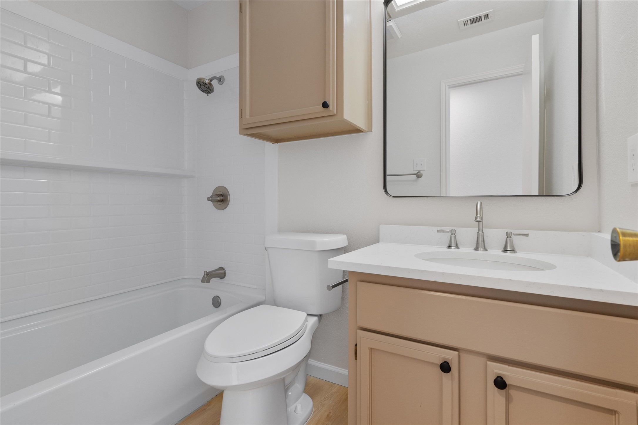 1401 Plum Creek Road Cedar Park, TX 78613 - Photo 22 of 30 Bathroom with vanity, tub / shower combination, and light wood finished floors