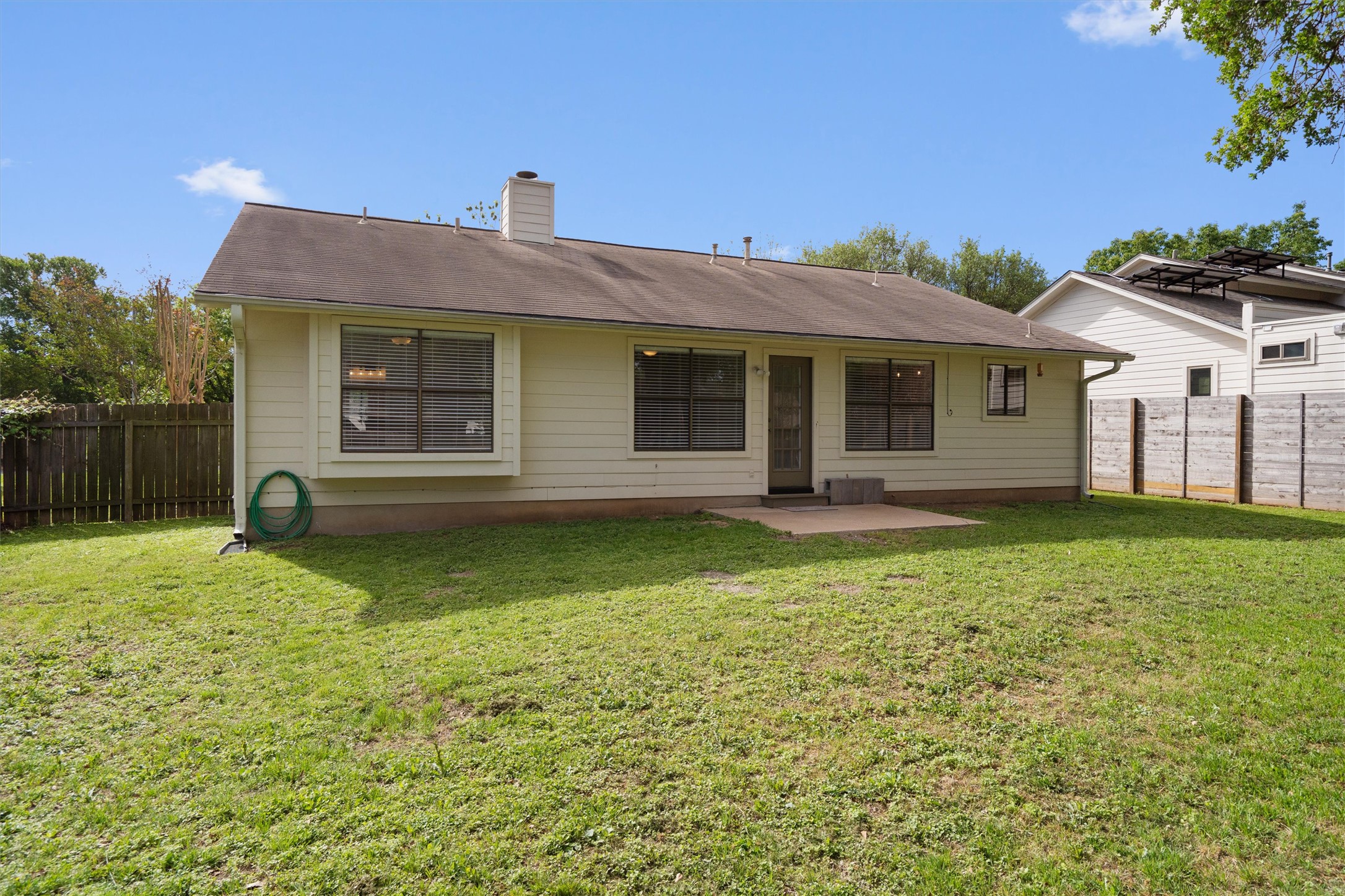 1401 Plum Creek Road Cedar Park, TX 78613 - Photo 25 of 30 Back of house with a patio area, a fenced backyard, and a chimney