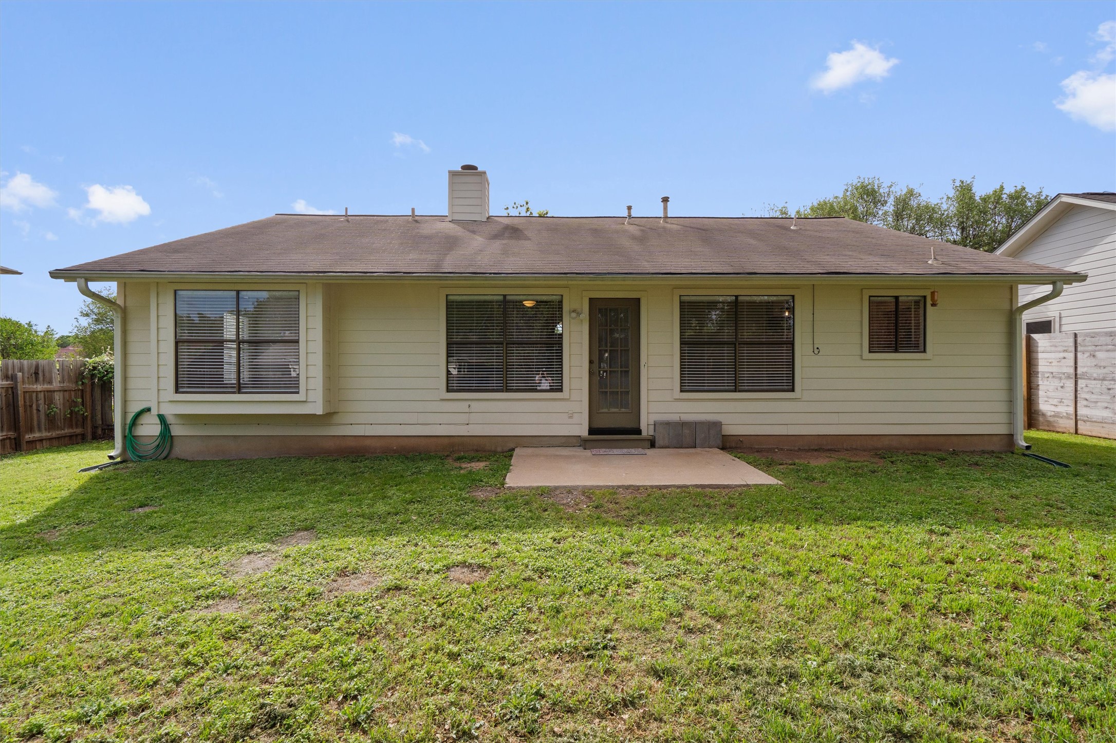 1401 Plum Creek Road Cedar Park, TX 78613 - Photo 26 of 30 Rear view of house featuring a fenced backyard, a patio, and a chimney