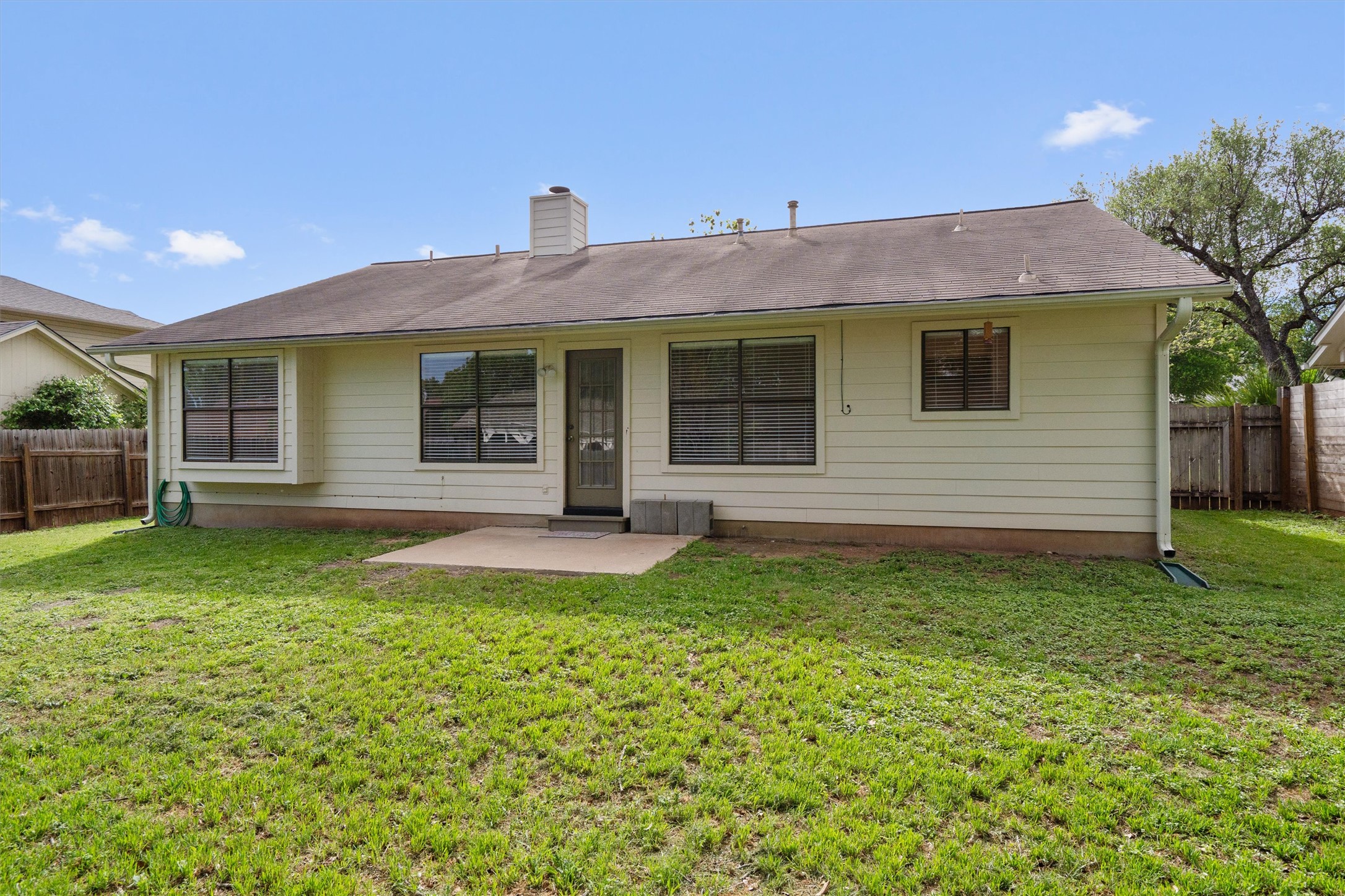 1401 Plum Creek Road Cedar Park, TX 78613 - Photo 27 of 30 Back of house with a fenced backyard, a patio area, and a chimney