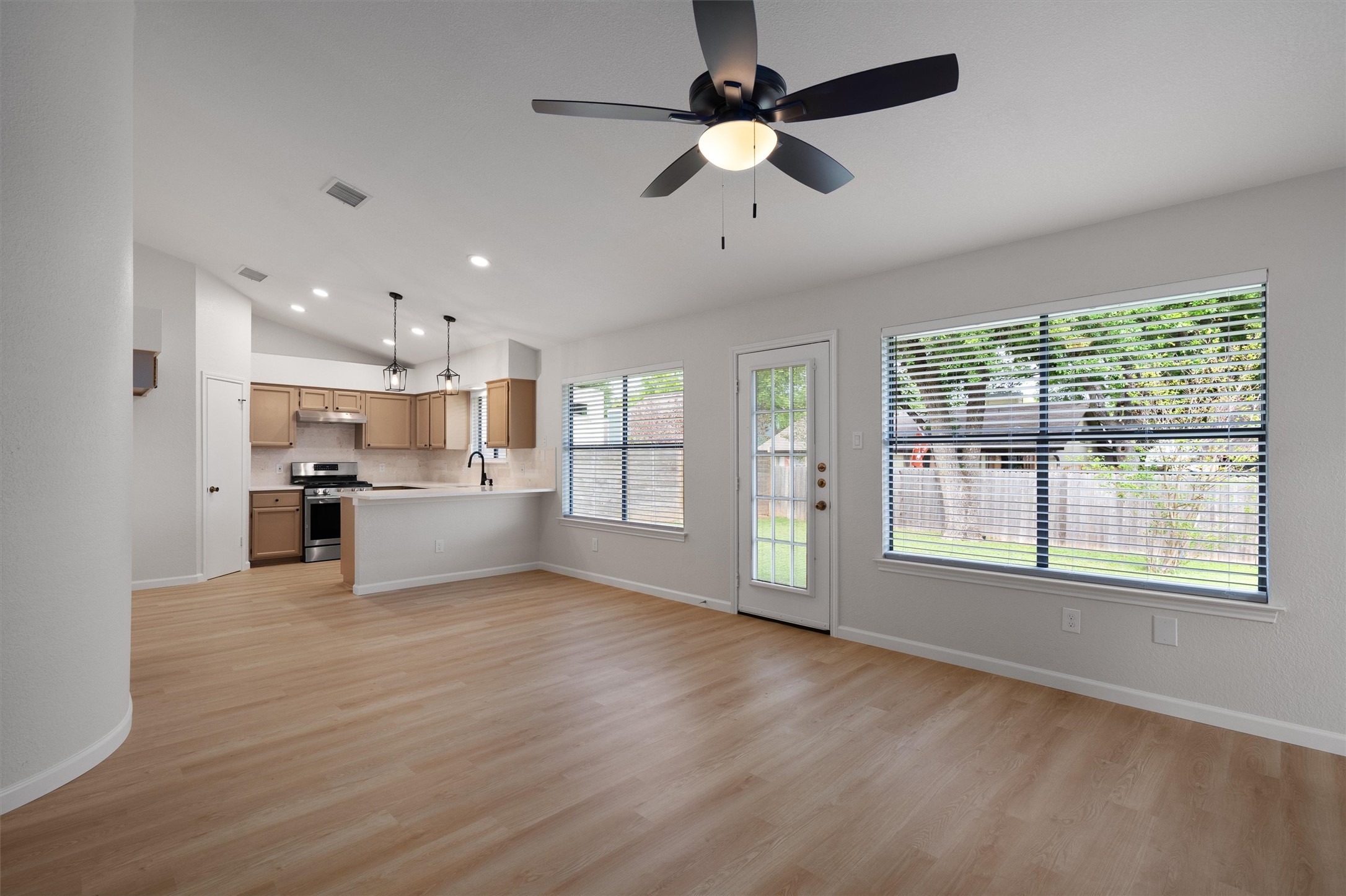 1401 Plum Creek Road Cedar Park, TX 78613 - Photo 29 of 30 Kitchen with open floor plan, a peninsula, lofted ceiling, light countertops, and a ceiling fan