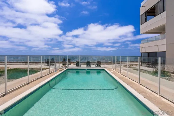 a view of a swimming pool with a chair and city view