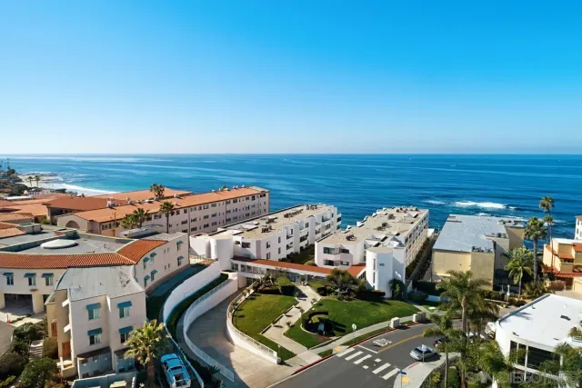 a kitchen with a dining table chairs and view living room